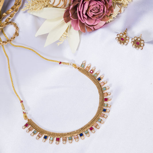 A SHORT NECKLACE WITH MULTI-COLOR STONES ADDS VIBRANT FLAIR.