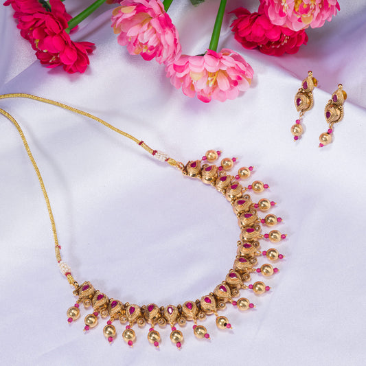 GOLD TONE WITH PINK STONES EXUDES A CHIC, VIBRANT ALLURE.