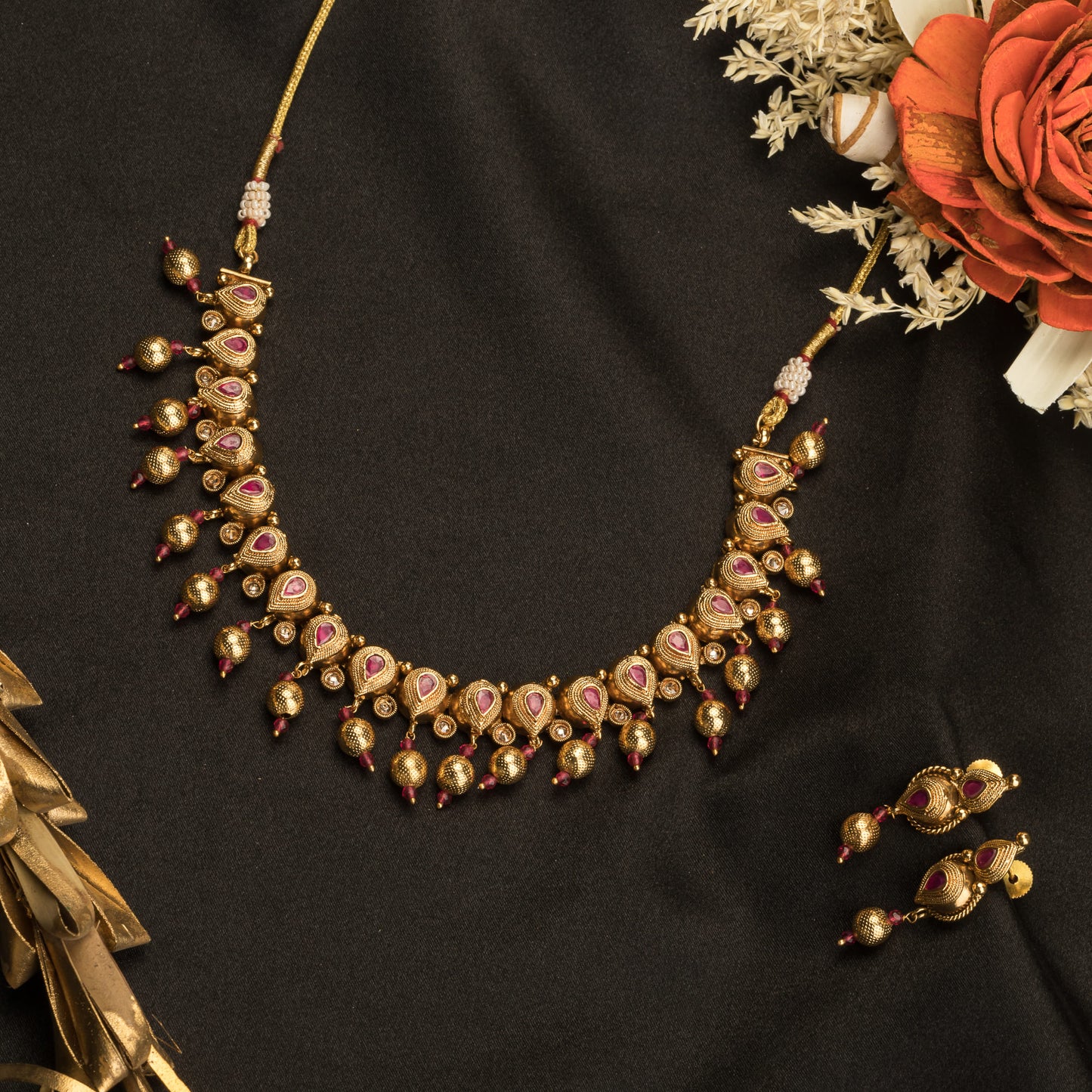 GOLD TONE WITH PINK STONES EXUDES A CHIC, VIBRANT ALLURE.