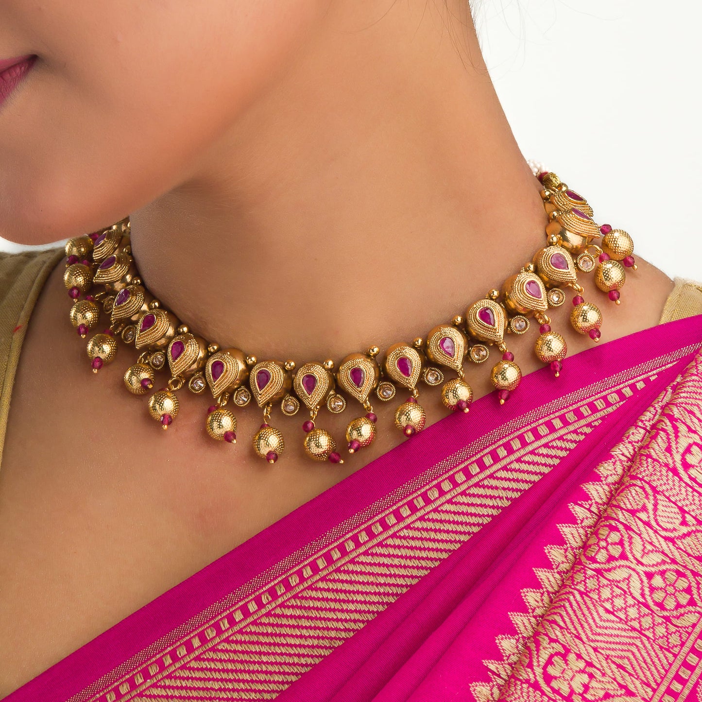 GOLD TONE WITH PINK STONES EXUDES A CHIC, VIBRANT ALLURE.