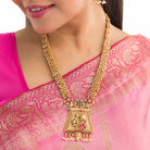 Long temple necklace with white pearls radiates timeless golden elegance for festive occasions.
