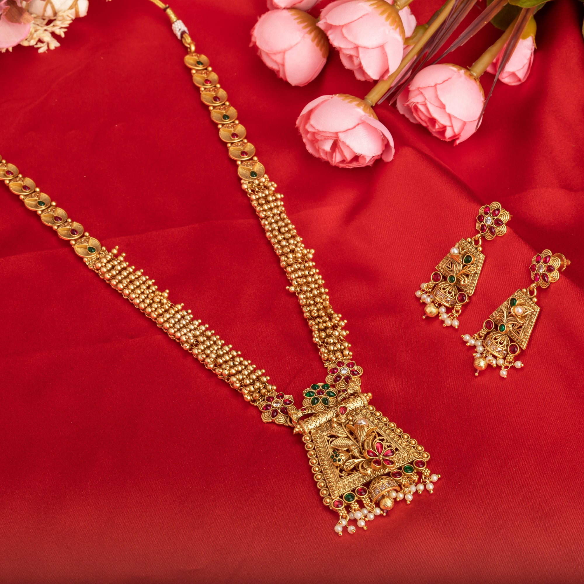 Long temple necklace with white pearls radiates timeless golden elegance for festive occasions.
