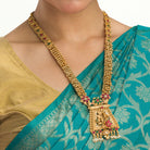 Long temple necklace with white pearls radiates timeless golden elegance for festive occasions.
