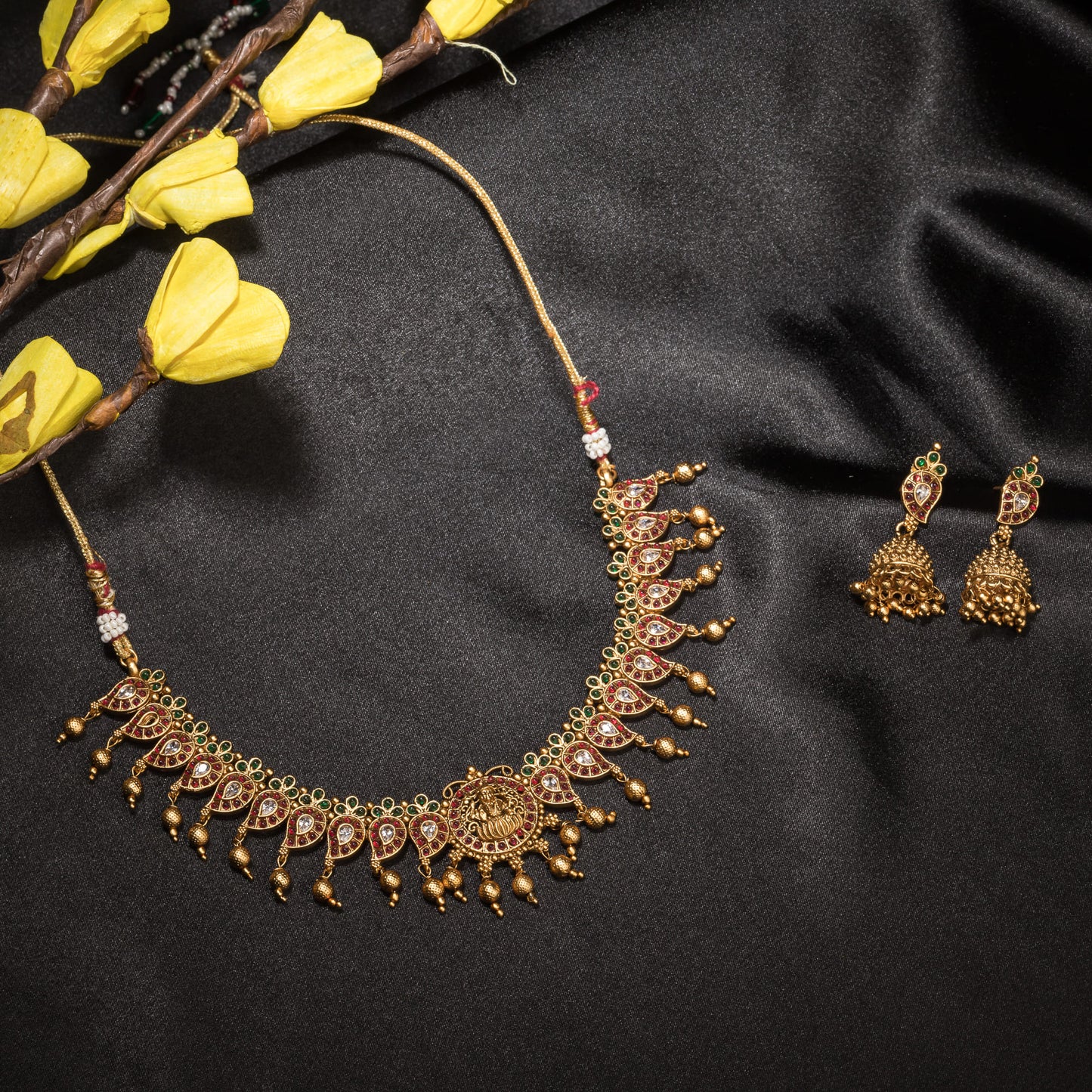 A GOLD  NECKLACE WITH MULTI-COLOR STONES OFFERS VIBRANT ELEGANCE.