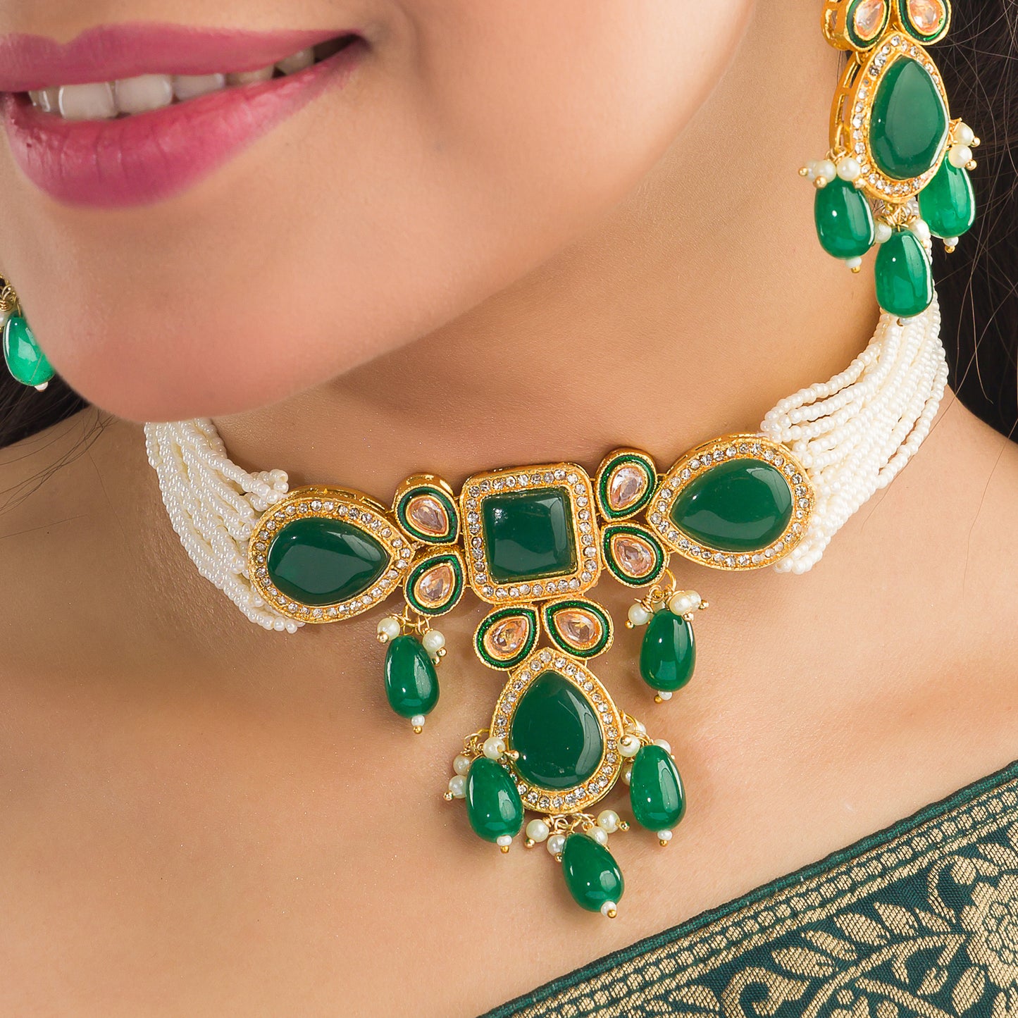 A GREEN KUNDAN AND WHITE PEARL CHOKER OFFERS ELEGANT, VIBRANT FLAIR.