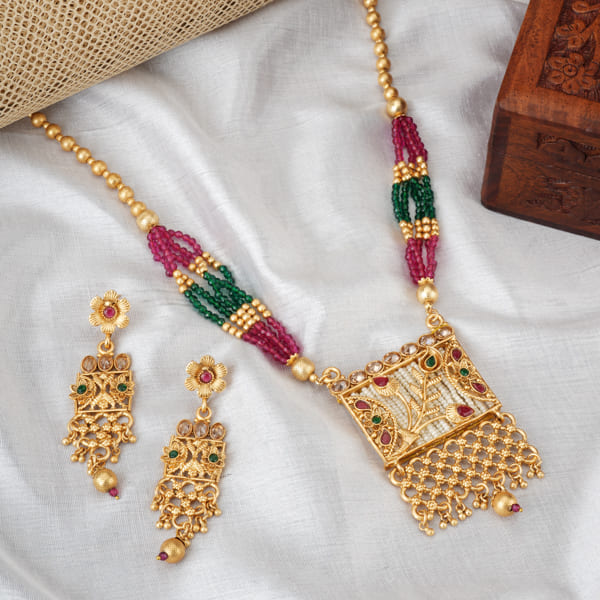 A GOLD LONG NECKLACE WITH MULTI-COLOR STONES OFFERS VIBRANT ELEGANCE.