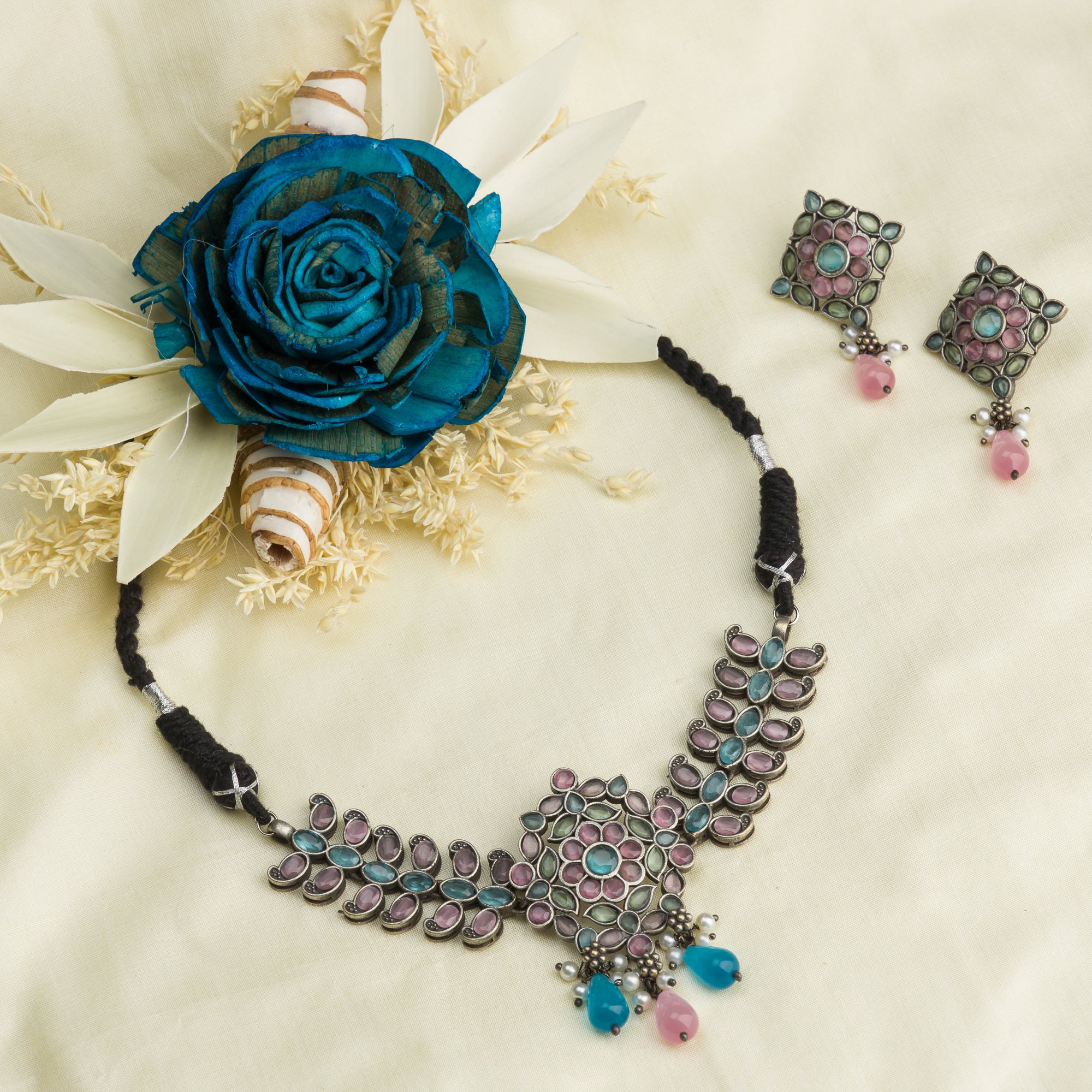 "Oxidized choker with multicolor stones adds a unique and vibrant touch for festive occasions."
