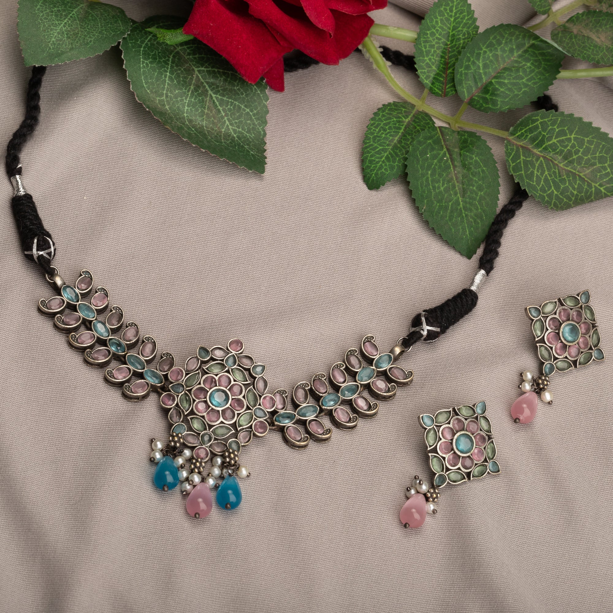 "Oxidized choker with multicolor stones adds a unique and vibrant touch for festive occasions."
