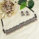 "Oxidized peacock choker with white pearls and colorful stones radiates vintage charm."
