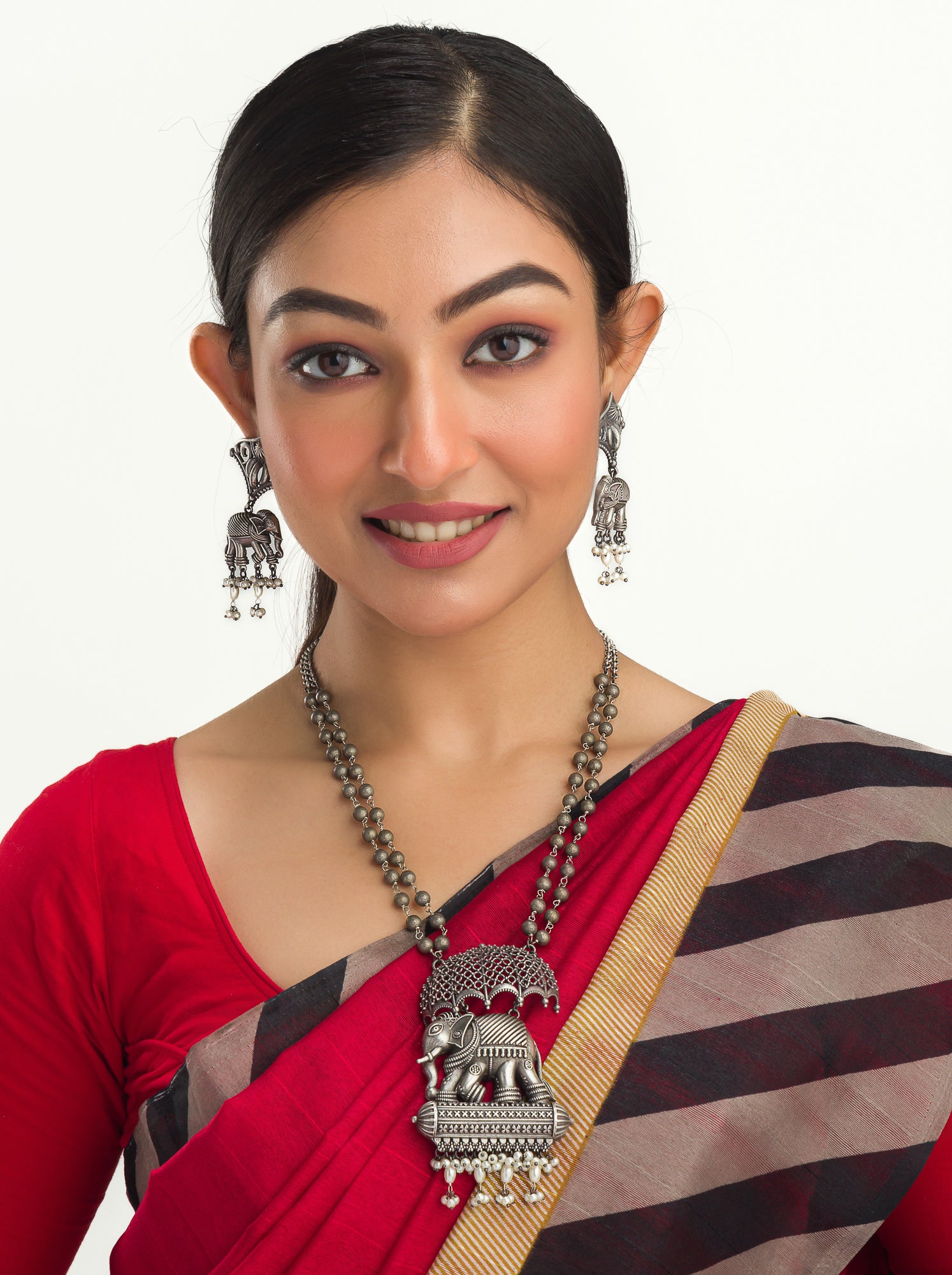 "Oxidized long necklace with umbrella, elephant motifs, and white pearls exudes vintage elegance."
