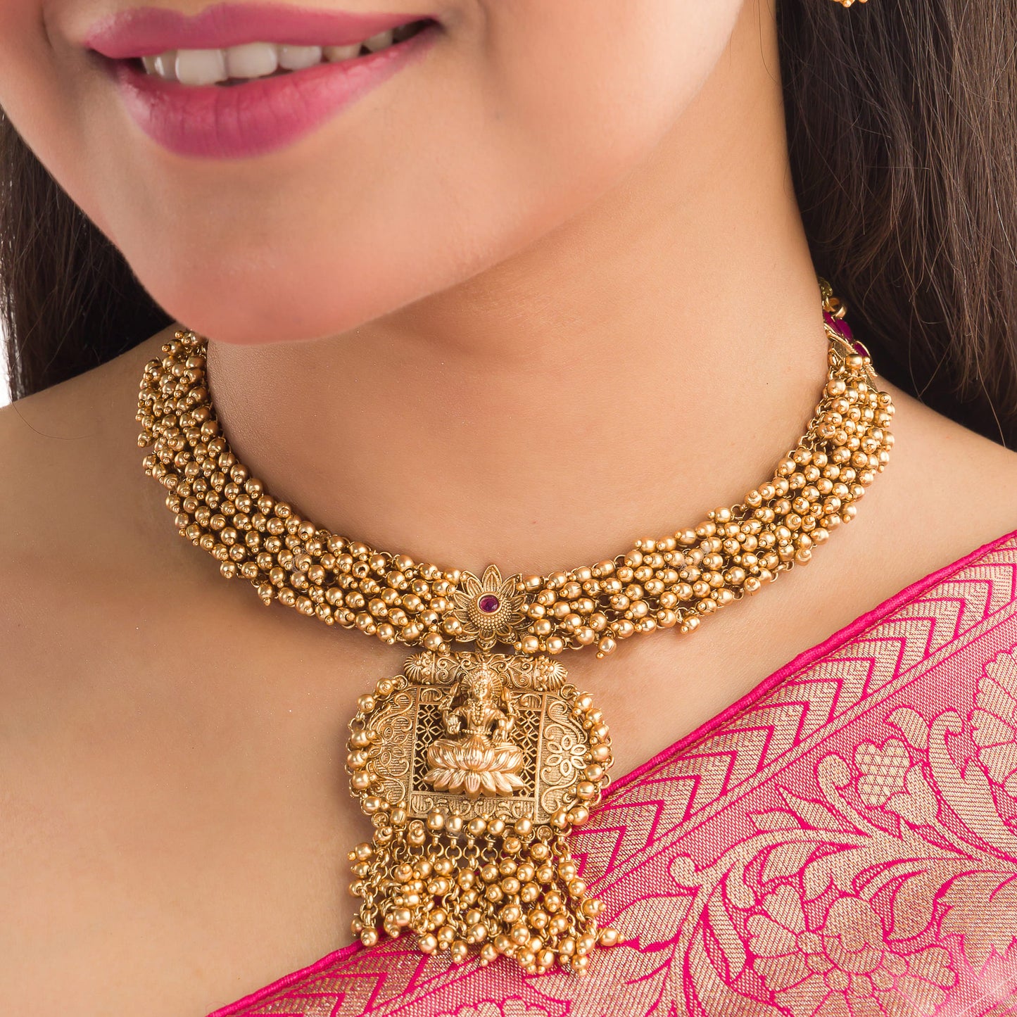 ELEGANT GOLDEN TEMPLE CHOKER EMBELLISHED WITH SMALL GOLDEN BEADS FOR A SOPHISTICATED AND TRADITIONAL LOOK.