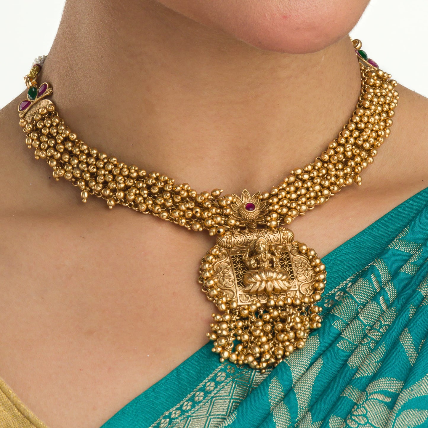 ELEGANT GOLDEN TEMPLE CHOKER EMBELLISHED WITH SMALL GOLDEN BEADS FOR A SOPHISTICATED AND TRADITIONAL LOOK.