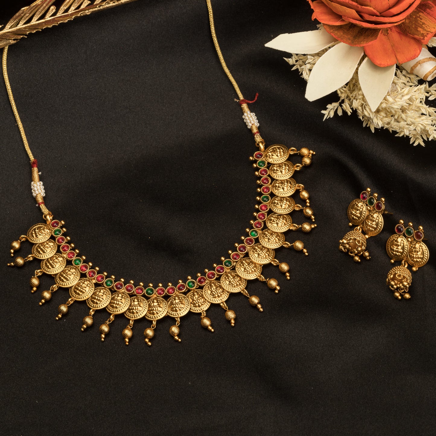 COIN-STYLE GOLD-TONE TEMPLE JEWELRY EXUDES CLASSIC ELEGANCE AND TRADITION.