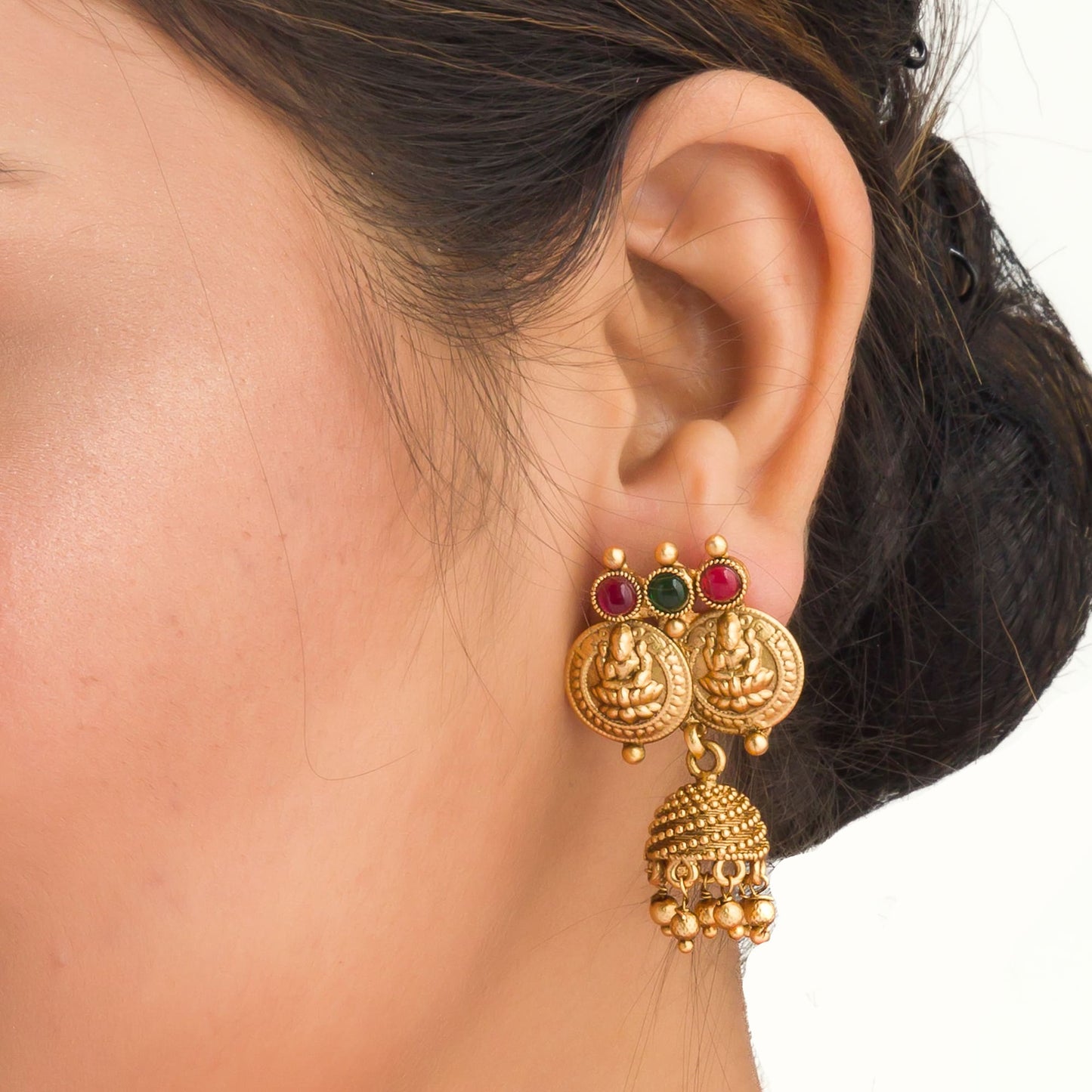 COIN-STYLE GOLD-TONE TEMPLE JEWELRY EXUDES CLASSIC ELEGANCE AND TRADITION.