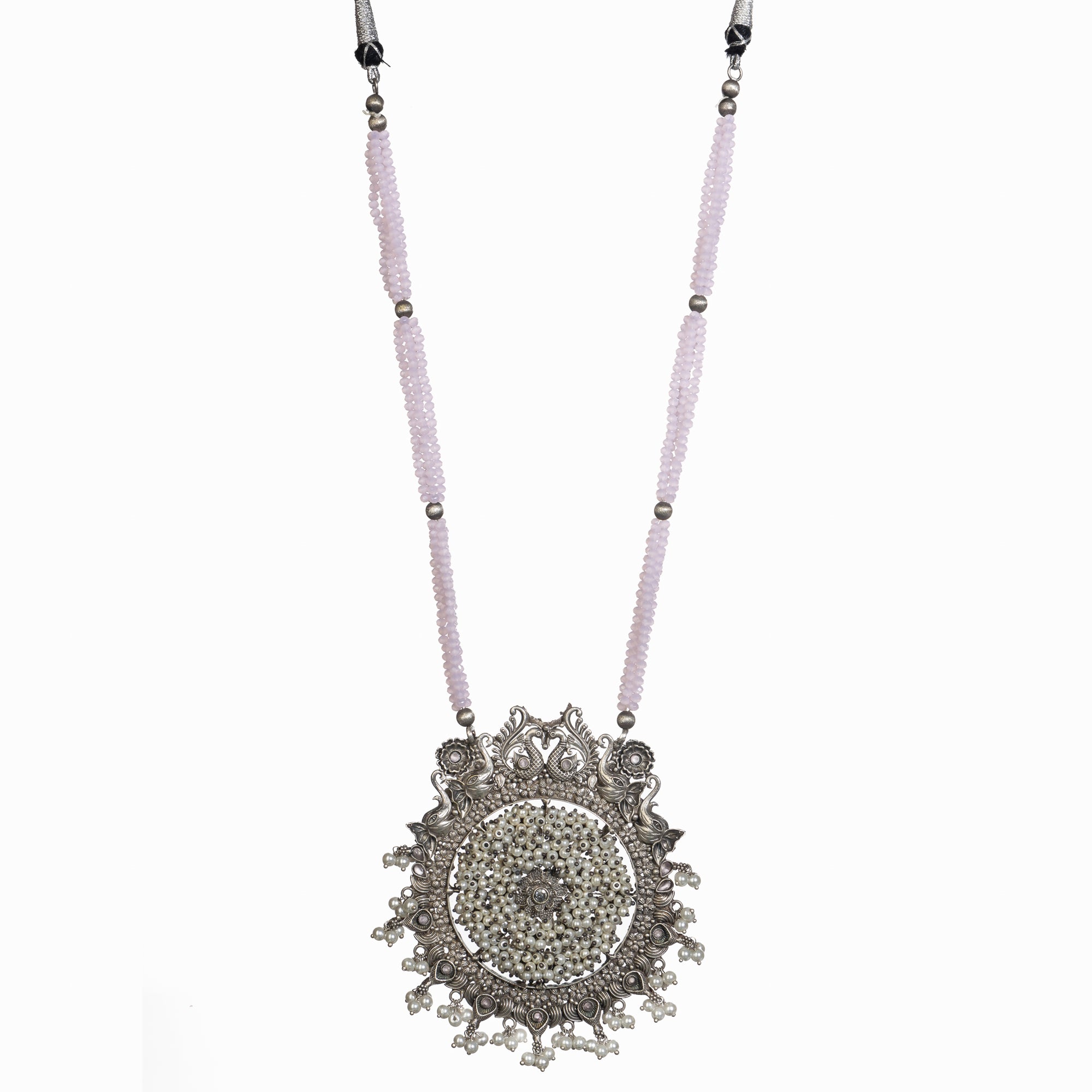 "Long oxidized necklace with pink and white pearls adds vintage elegance."
