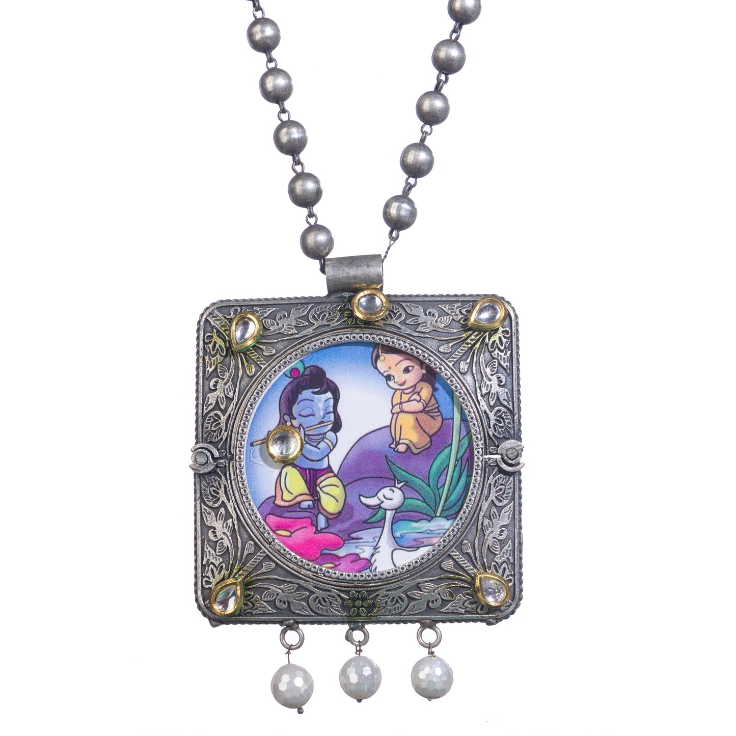 A LONG OXIDIZED NECKLACE WITH A RADHA KRISHNA IMAGE ADDS SPIRITUAL CHARM.