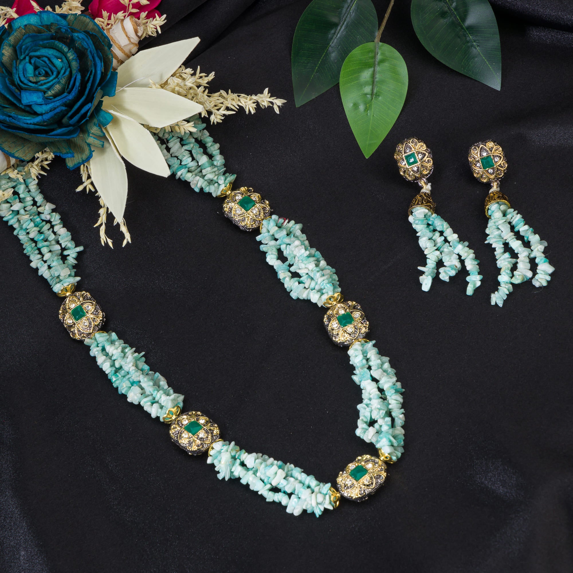 "Gold-tone long necklace with green sea stone offers a refreshing, natural touch."
