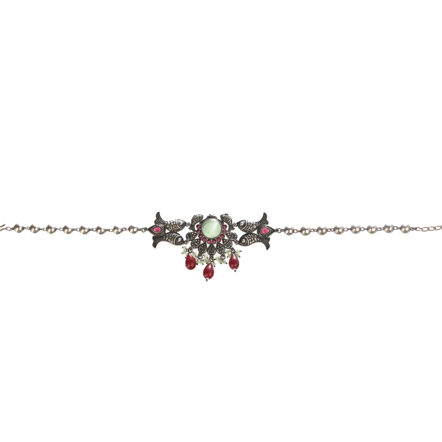 A FISH NECKLACE WITH LIGHT GREEN STONES AND MAROON KUNDAN BLENDS UNIQUE CHARM WITH RICH COLORS.