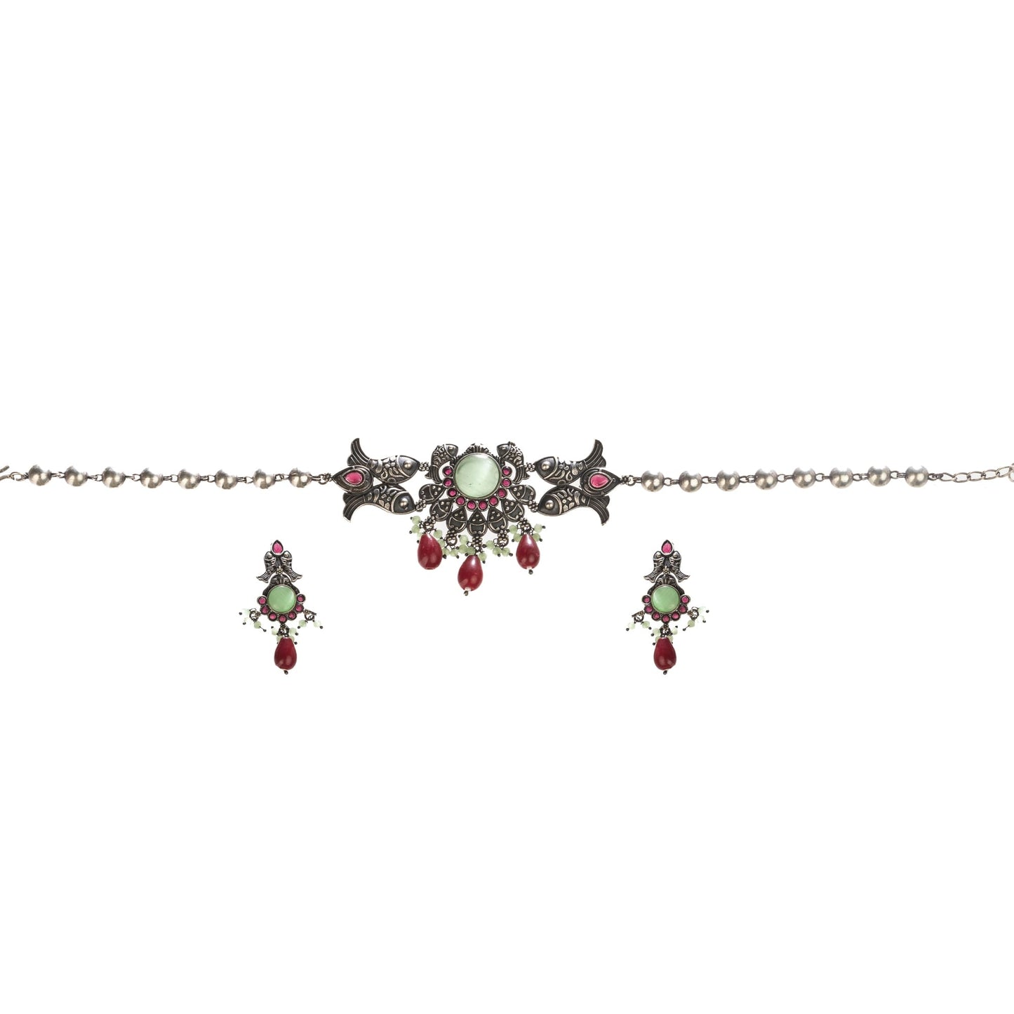 A FISH NECKLACE WITH LIGHT GREEN STONES AND MAROON KUNDAN BLENDS UNIQUE CHARM WITH RICH COLORS.