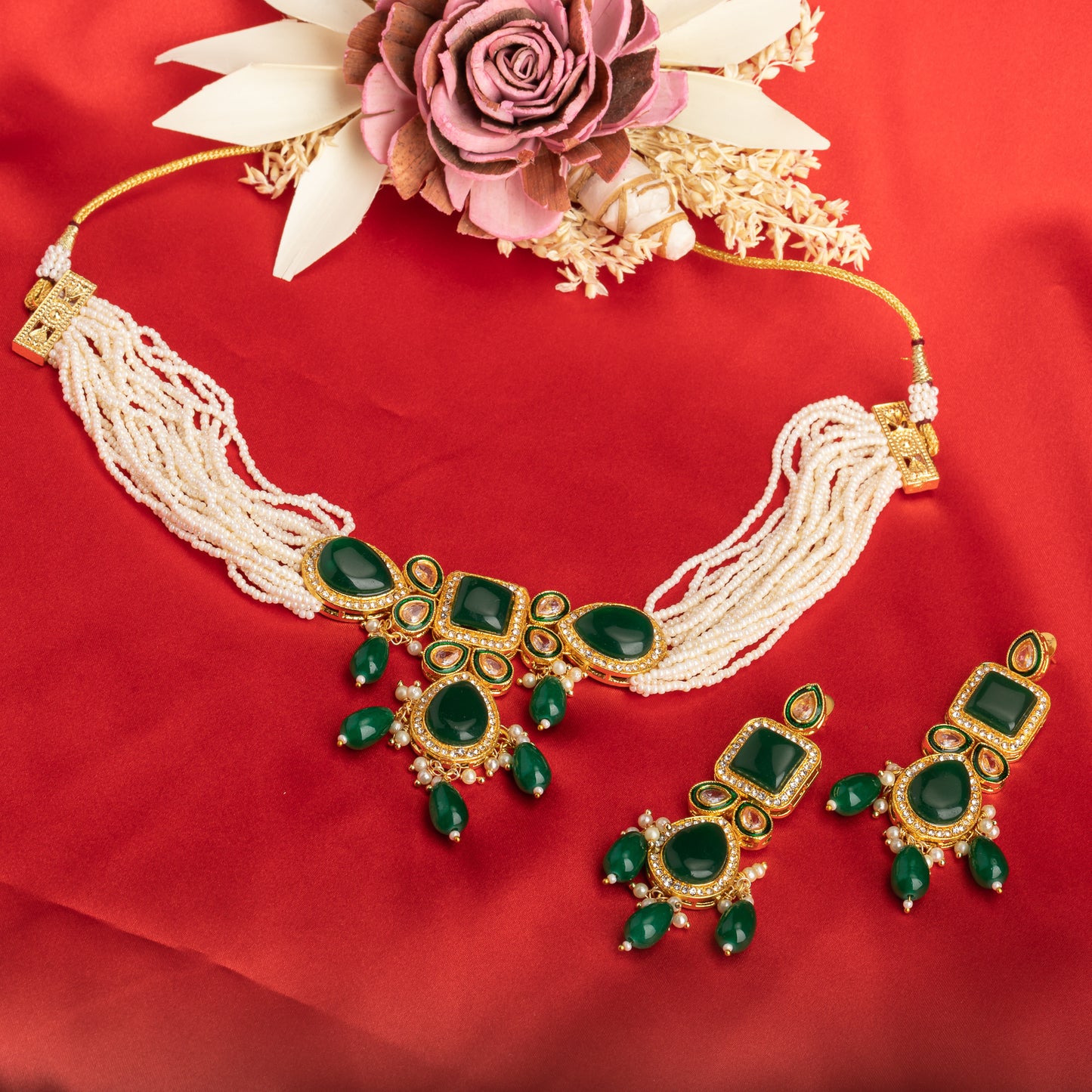 A GREEN KUNDAN AND WHITE PEARL CHOKER OFFERS ELEGANT, VIBRANT FLAIR.