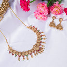 Gold-tone temple necklace set with golden beads offers timeless elegance
