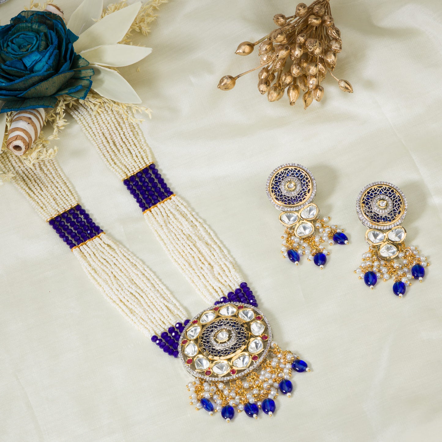 A MAHARANI LONG NECKLACE WITH BLUE KUNDAN AND WHITE PEARLS EXUDES ROYAL SOPHISTICATION.