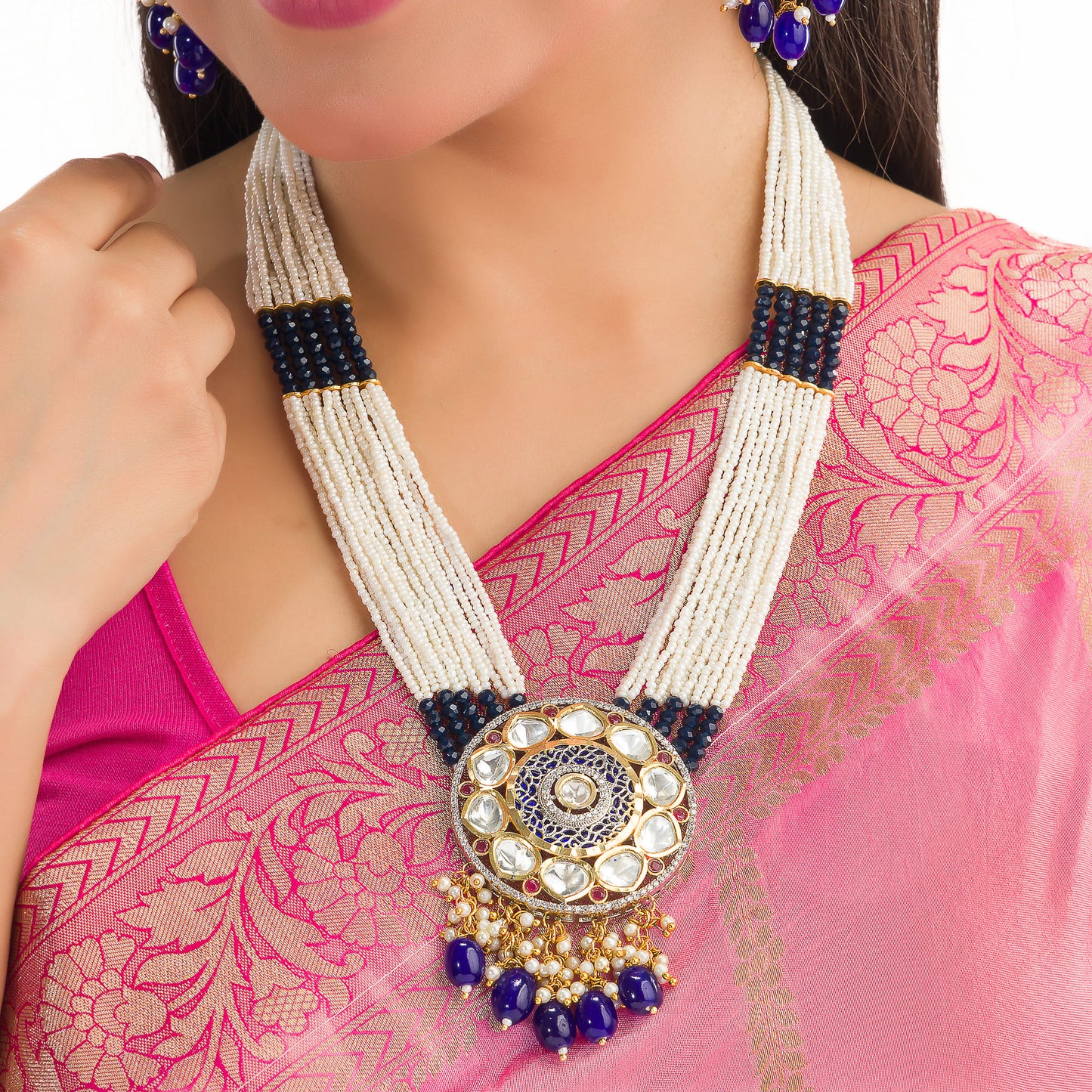 A MAHARANI LONG NECKLACE WITH BLUE KUNDAN AND WHITE PEARLS EXUDES ROYAL SOPHISTICATION.