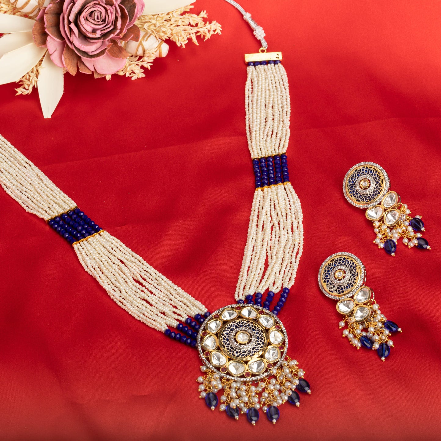 A MAHARANI LONG NECKLACE WITH BLUE KUNDAN AND WHITE PEARLS EXUDES ROYAL SOPHISTICATION.