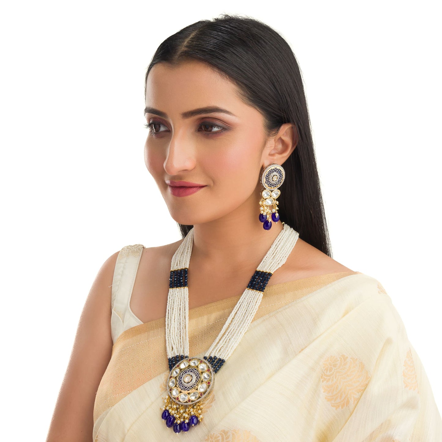 A MAHARANI LONG NECKLACE WITH BLUE KUNDAN AND WHITE PEARLS EXUDES ROYAL SOPHISTICATION.