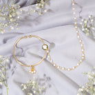 "Gold-polish nath with white pearls offers classic, elegant charm."
