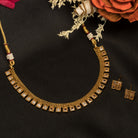 Gold-tone necklace with fitted stones for a sleek, elegant look.
