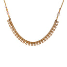 Gold-tone necklace with fitted stones for a sleek, elegant look.
