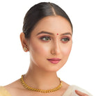 Gold-tone necklace with fitted stones for a sleek, elegant look.
