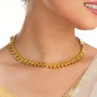 Gold-tone necklace with fitted stones for a sleek, elegant look.
