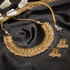 Gold-tone necklace with coin design and pearls exudes timeless elegance.
