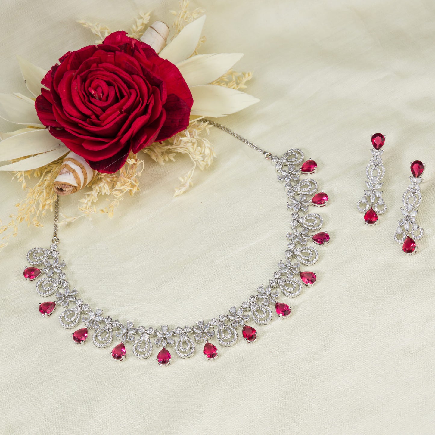 A stunning red and clear necklace set adds a bold, elegant touch to any outfit.