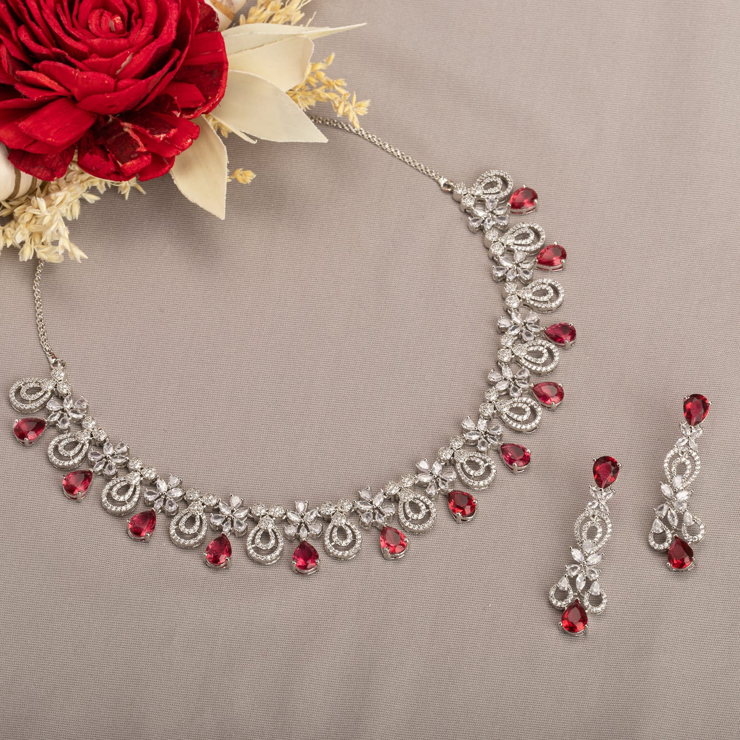 A stunning red and clear necklace set adds a bold, elegant touch to any outfit.