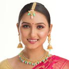 Elegant bridal choker set with green and pink Kundan, adding a traditional, regal touch
