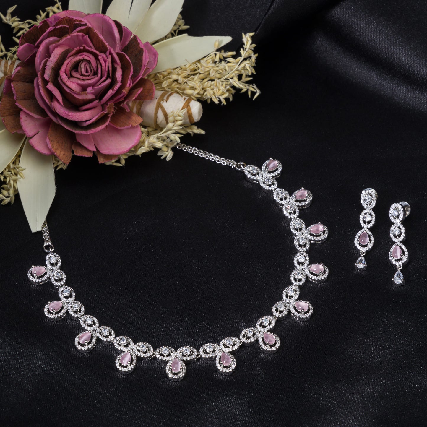 A ZIRCON NECKLACE FEATURING PINK ZIRCON STONES COMBINES DAZZLING CLARITY WITH A VIBRANT, ROMANTIC TOUCH.