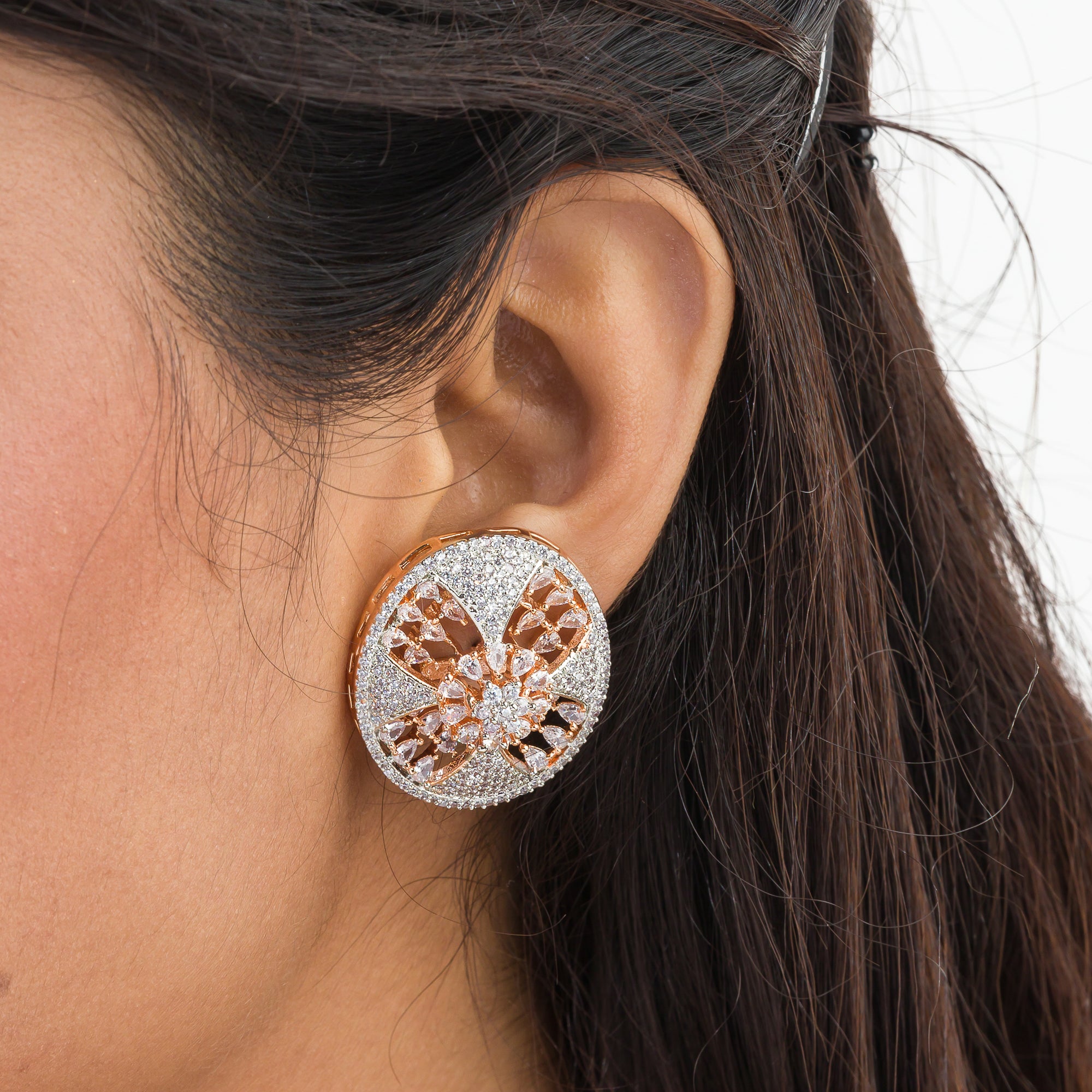 Gold-tone zircon round stud earrings add elegant sparkle for a sophisticated look.
