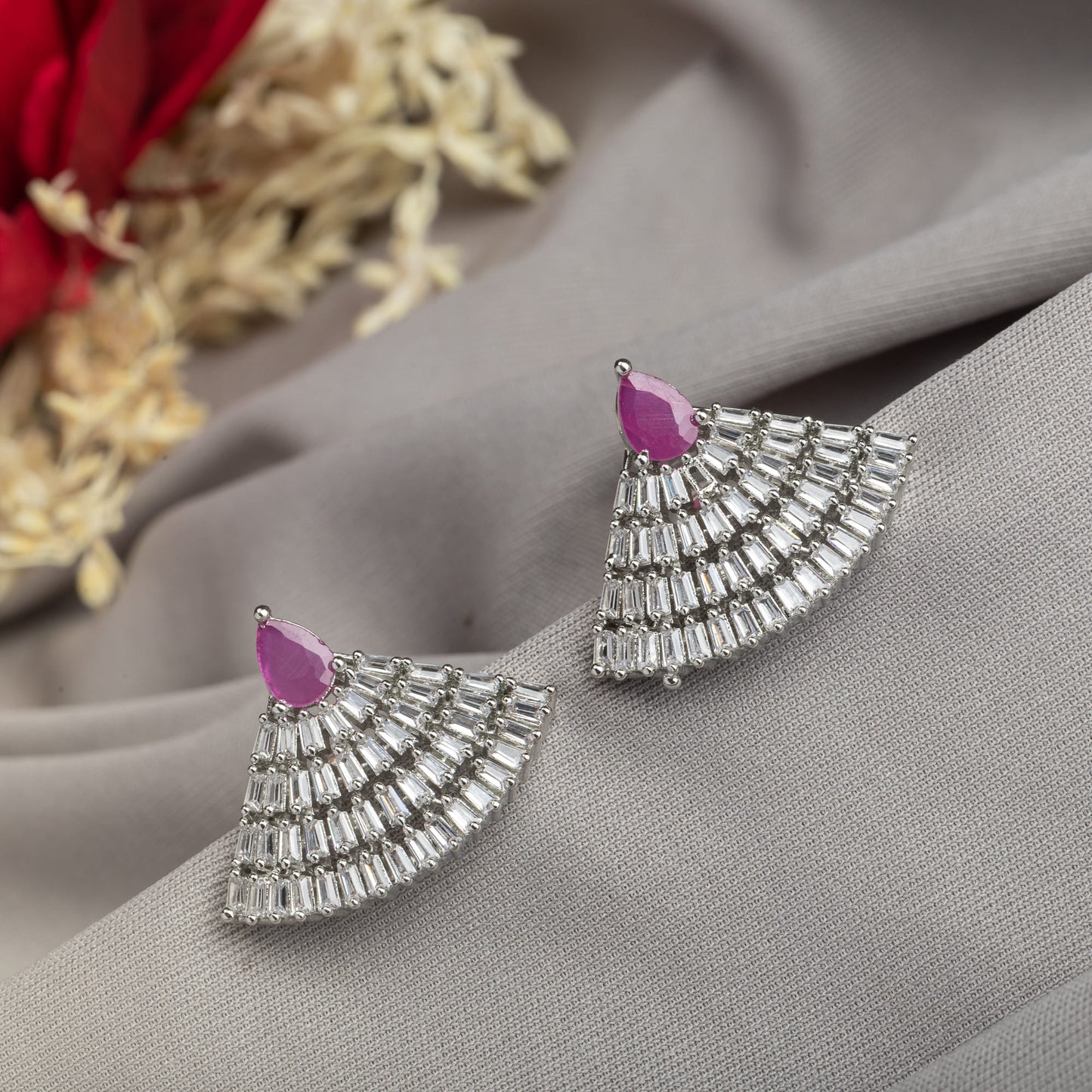 EARRING STUDS WITH PINK AND ZIRCON STONES OFFER A CHARMING COMBINATION OF VIBRANT COLOR AND SPARKLING ELEGANCE.