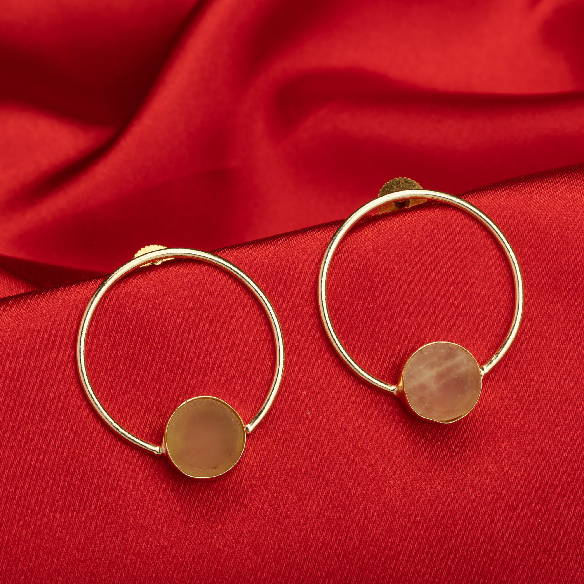 Classic round gold-tone earrings with wheat stones add a warm, sophisticated touch.
