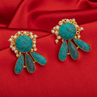 Blue gold-tone earrings with a pearl drop offer classic elegance and vibrant color.
