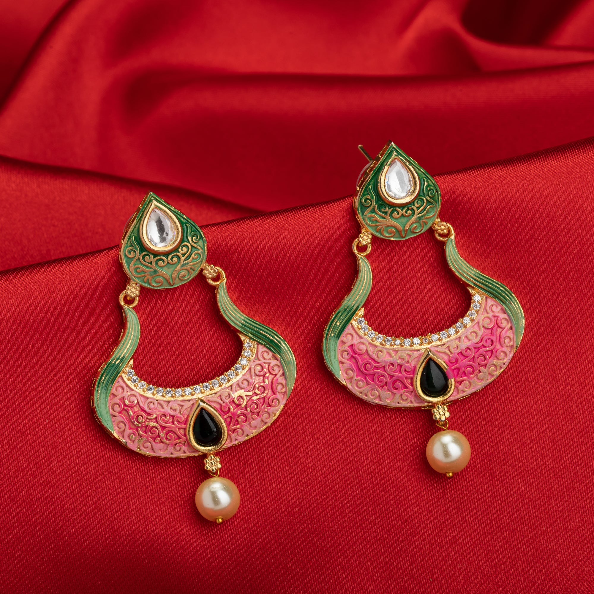 Gold-tone dangler earrings with Meenakari design offer intricate elegance and charm.
