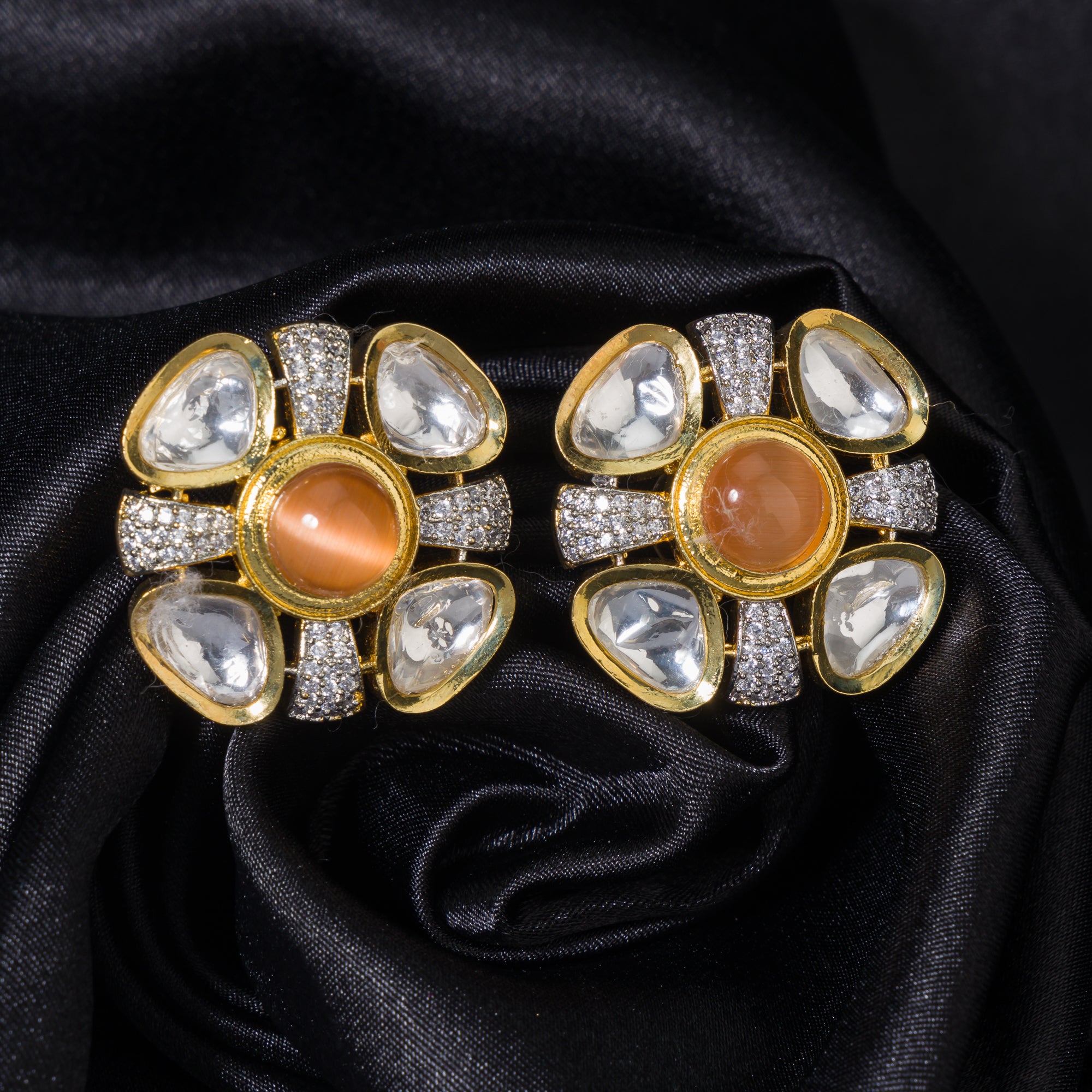 Orange zircon stud earrings with white accents, offering a pop of color and sparkle.
