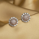 "Silver zircon studs with golden beads bring a subtle, stylish touch to casual elegance."
