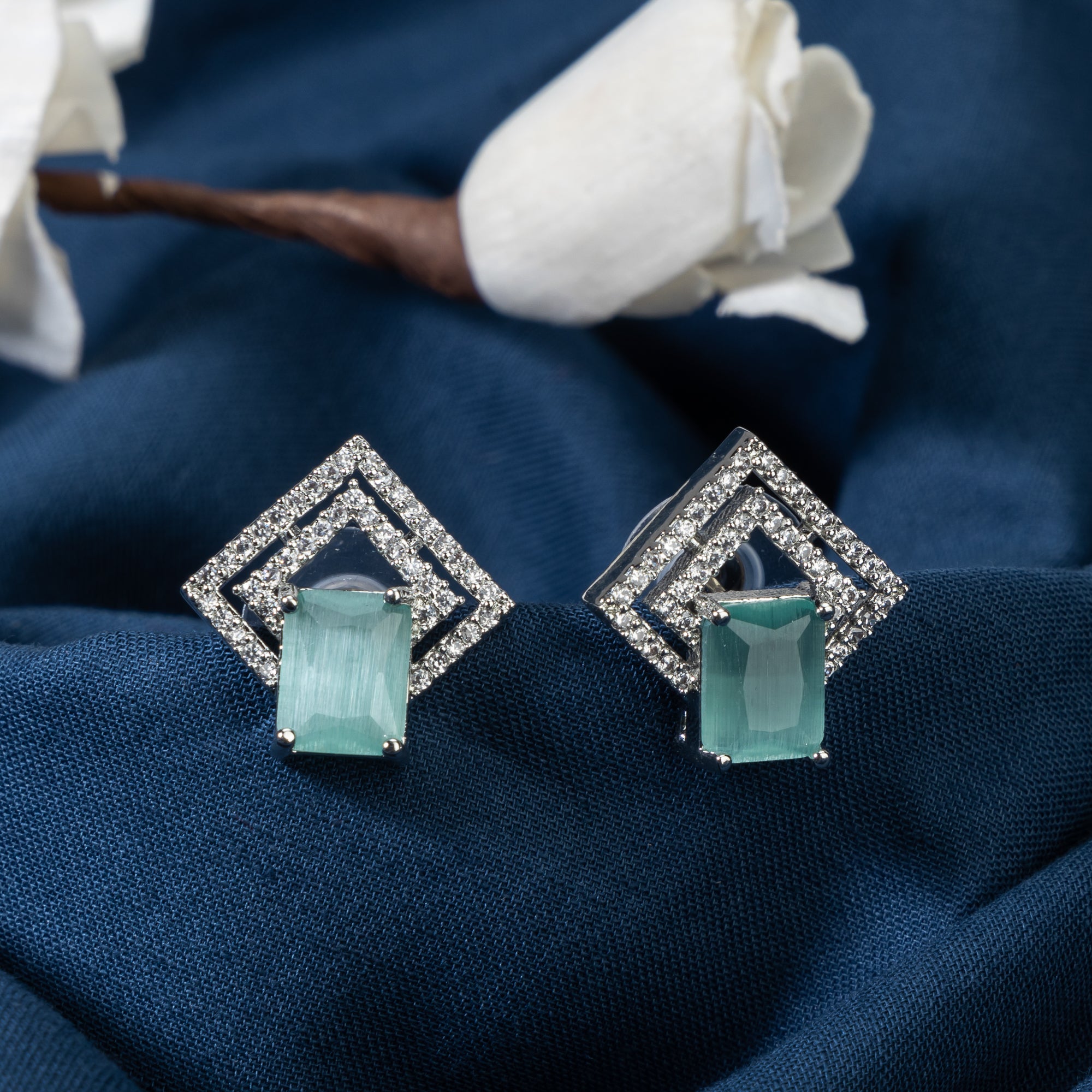 "Light green zircon studs sparkle with elegance, adding vibrant color to your casual look."
