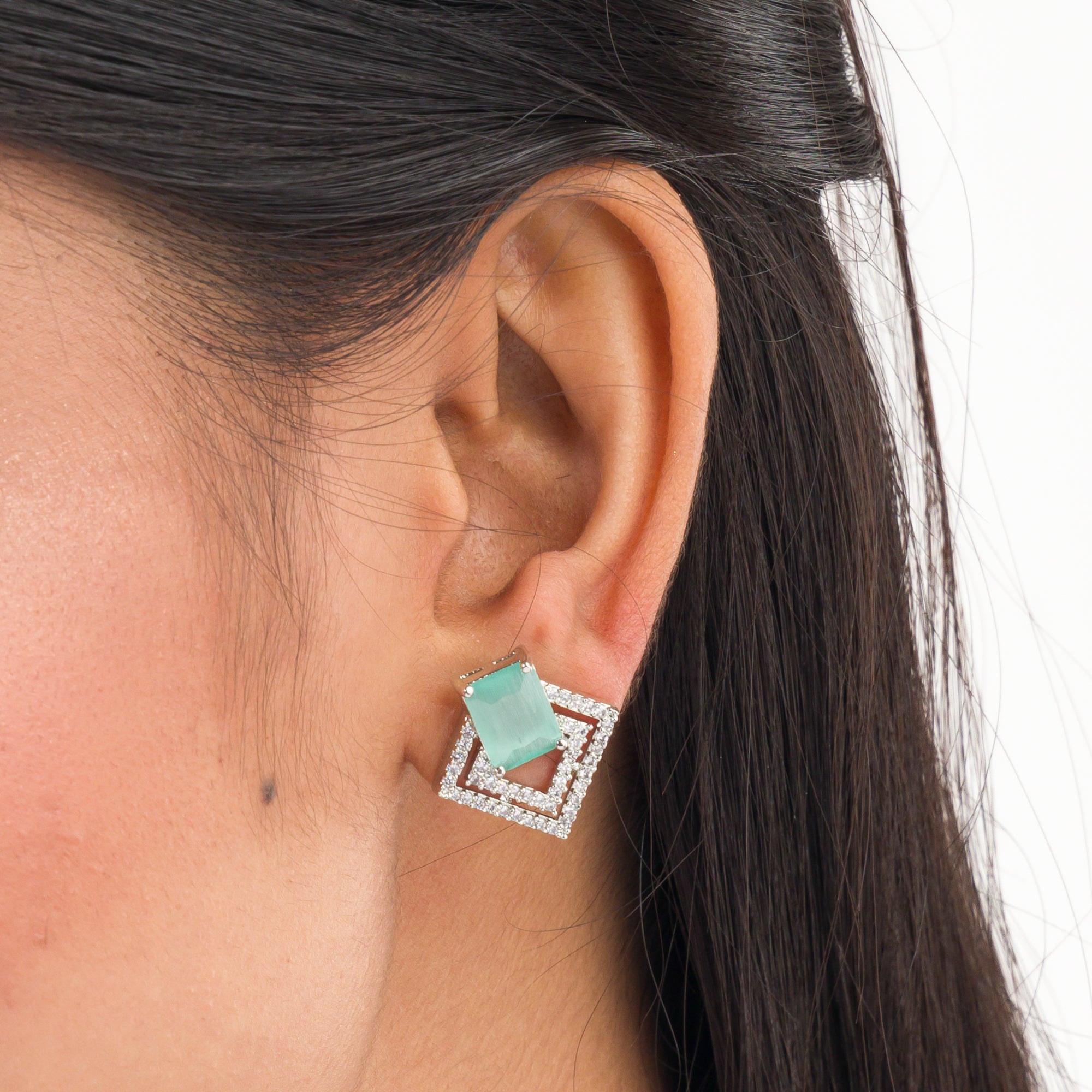 "Light green zircon studs sparkle with elegance, adding vibrant color to your casual look."
