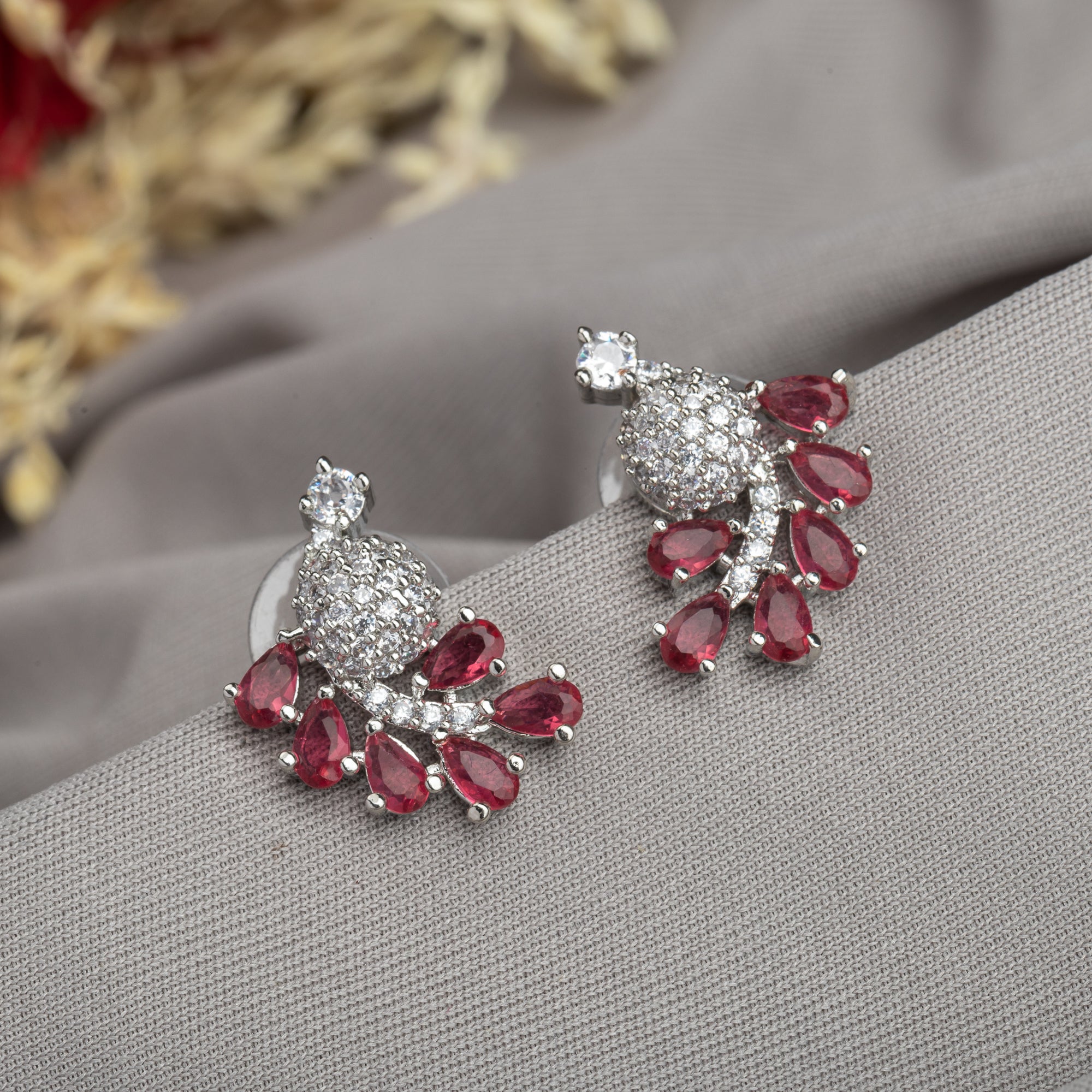 "Peacock-shaped pink zircon studs combine vibrant color with unique, elegant charm."
