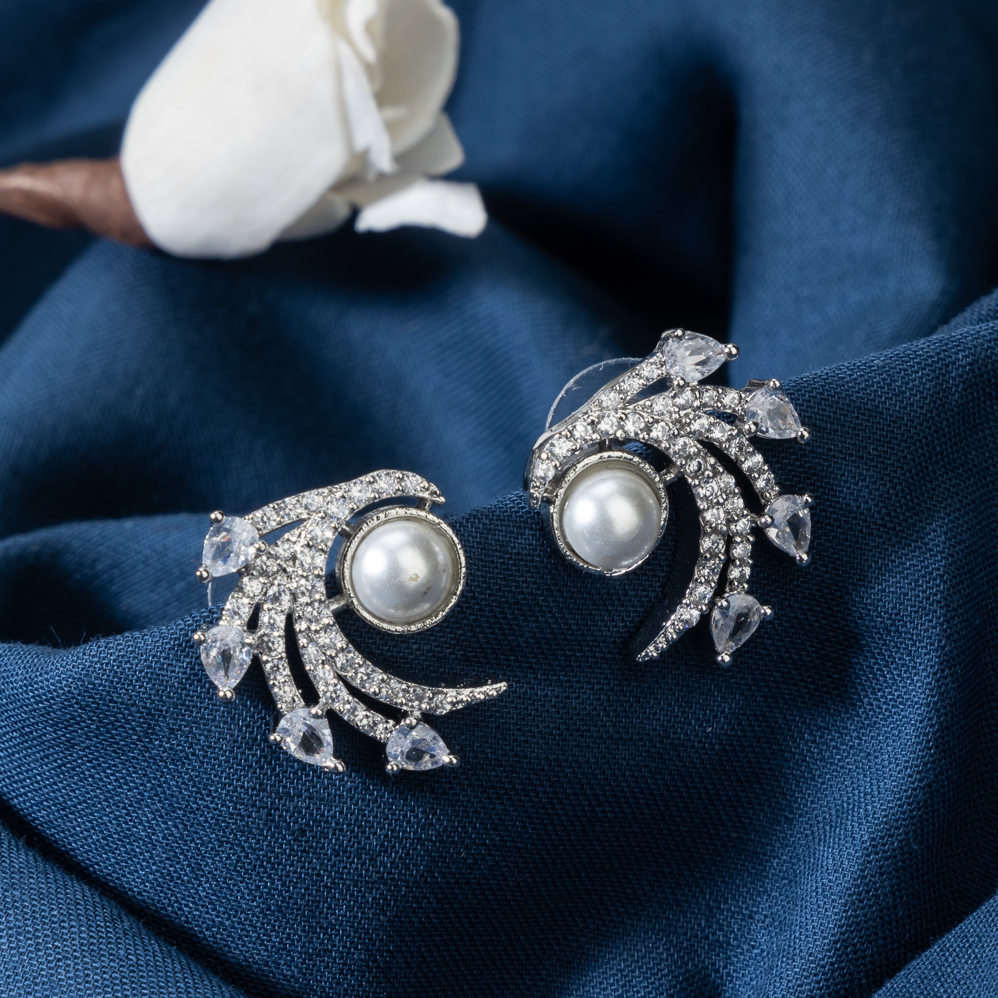 "Zircon studs with a single pearl offer sparkling brilliance and classic, sophisticated elegance."
